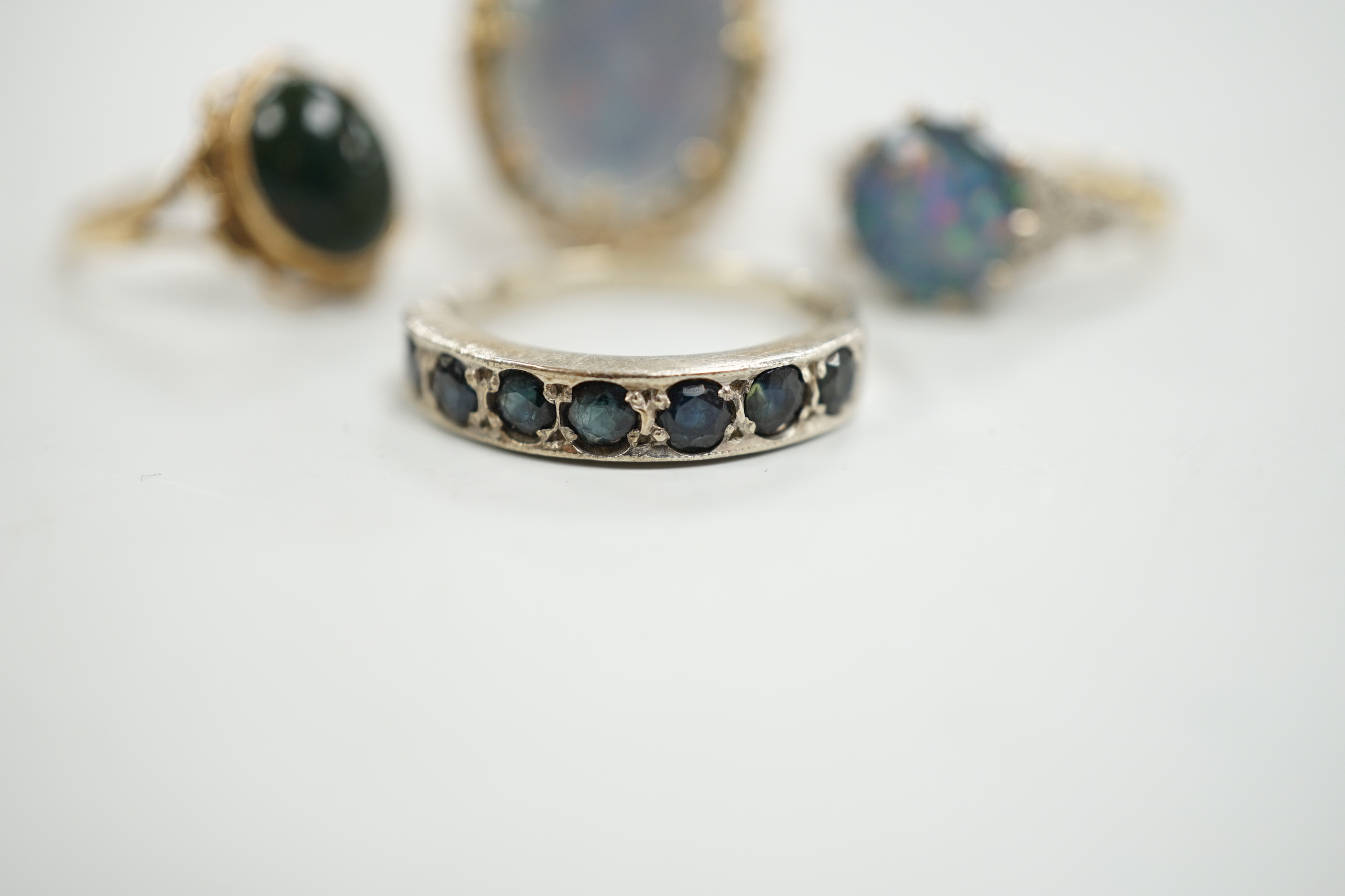A 1940's 18ct and black opal doublet set dress ring, with diamond chip set shoulders, size L, a 14c and oval doublet ring and two other 9ct and gem set rings.